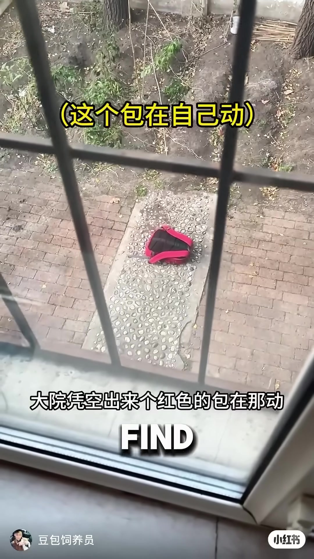 A red backpack lying on a floor, slightly moving as if something alive is inside.