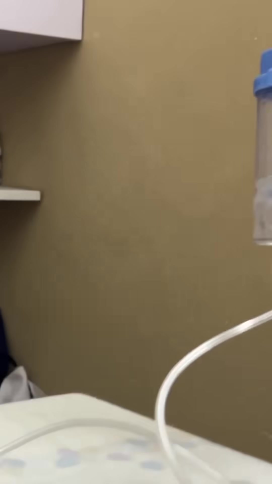 A veterinarian attending to a kitten with an oxygen mask.