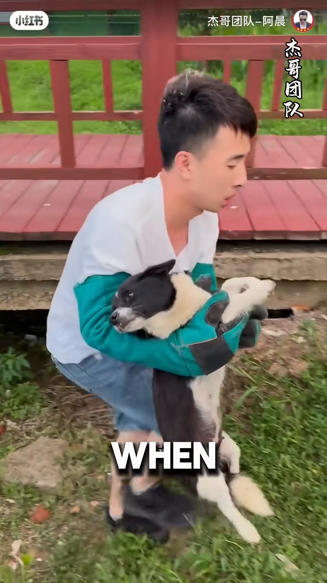 A man holding a mother dog found under a bridge.