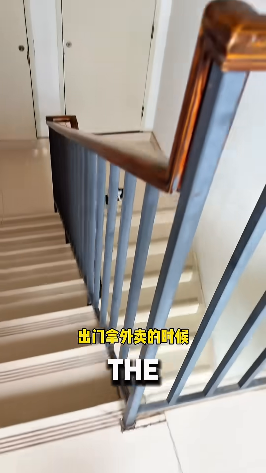 A small black and white puppy sits on the stairs, looking up.