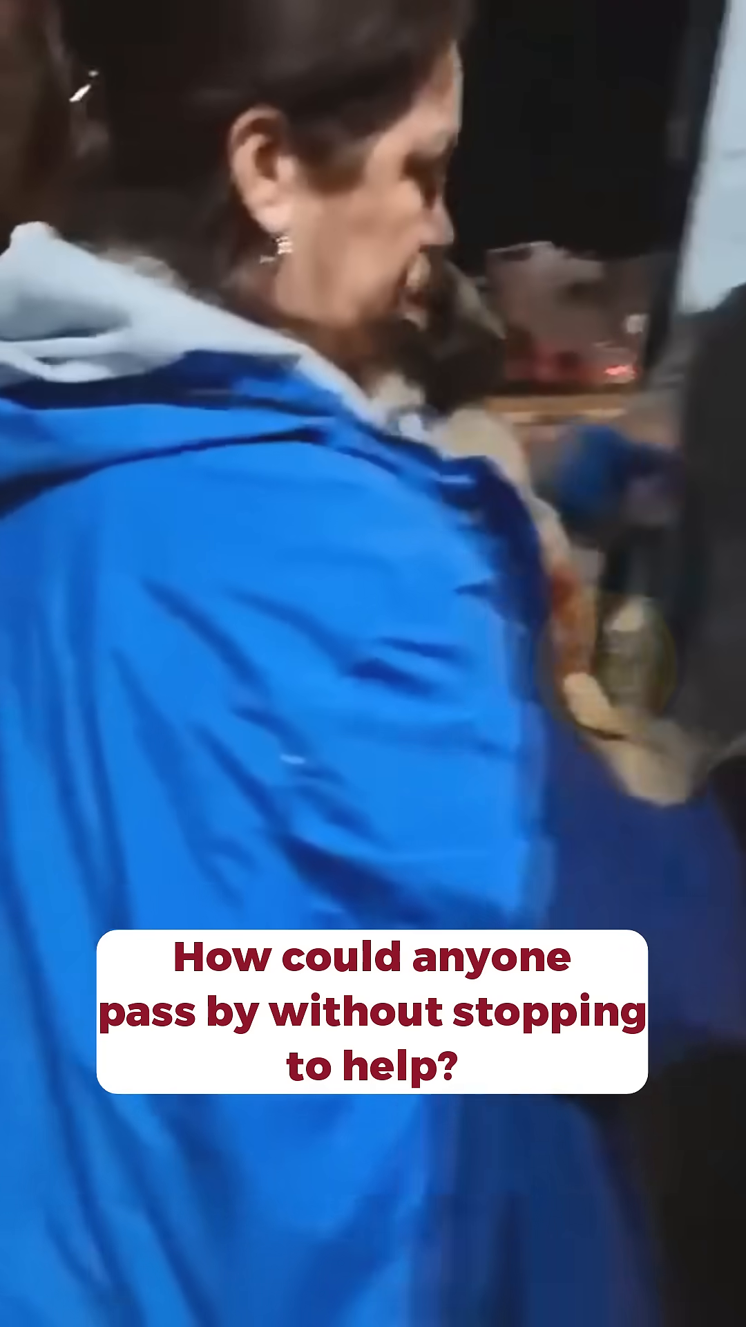 A man is putting a small puppy into a cage in the back of a vehicle.