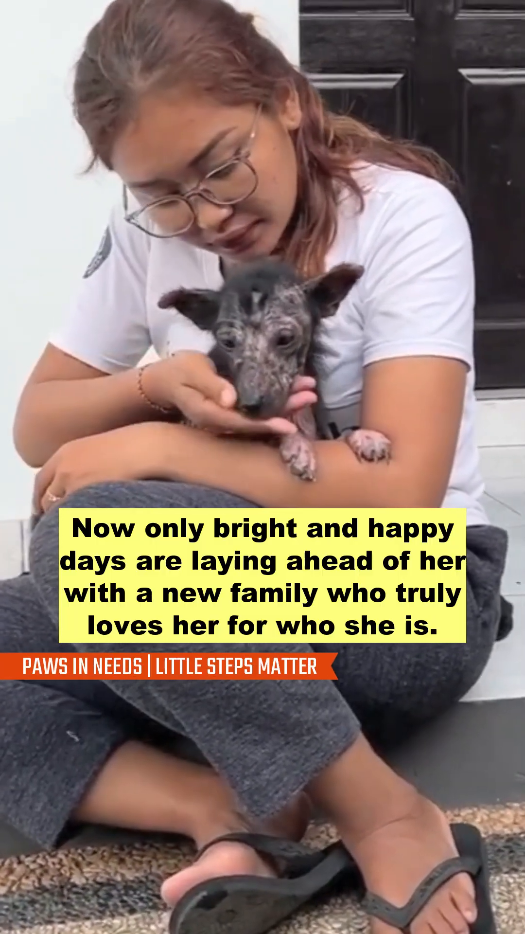 A woman tenderly holding the dog, Grace, who looks more comfortable and loved.